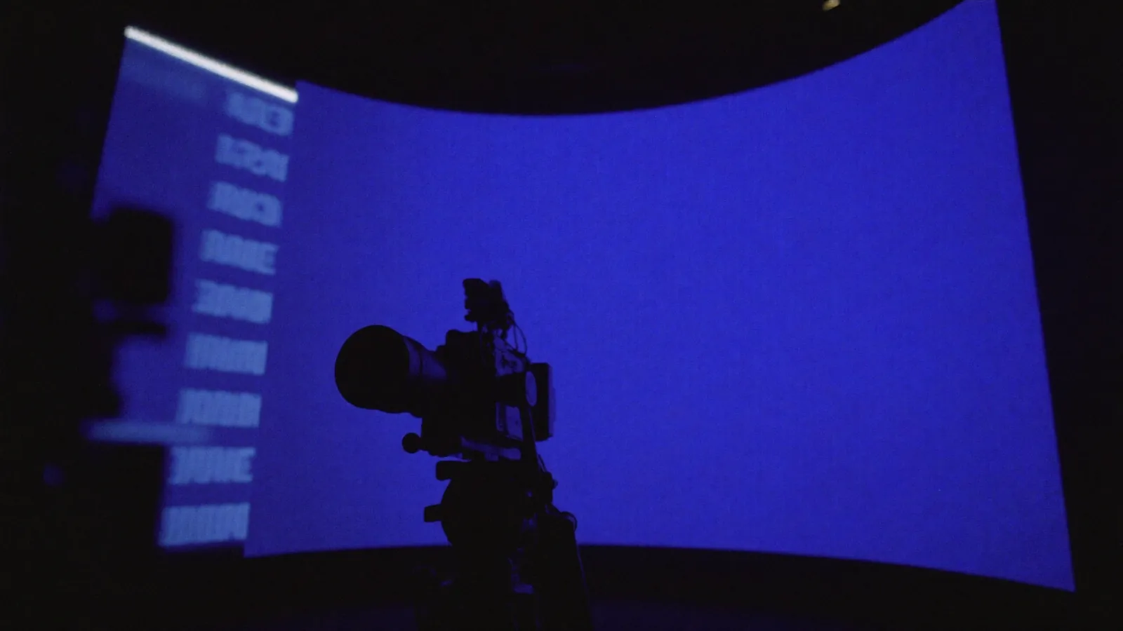A cinema camera against a calibrated indigo LED volume wall — ICVFX colour.