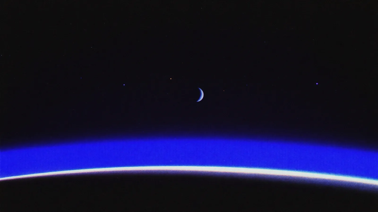 A dark planet limb with a thin indigo atmosphere glow — AI shot integration.